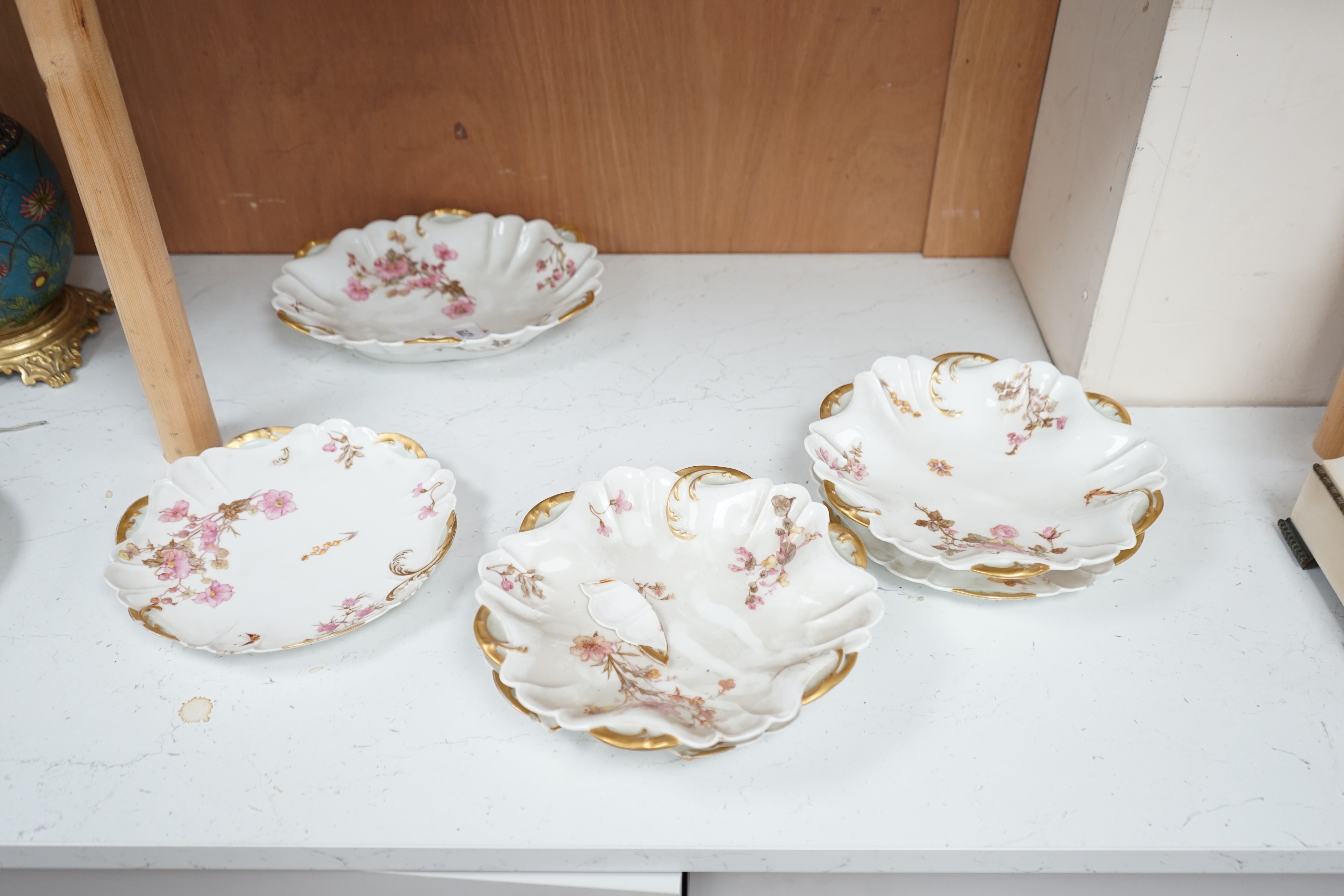 A Limoges eight piece dessert service with gilt decoration, 26cm wide